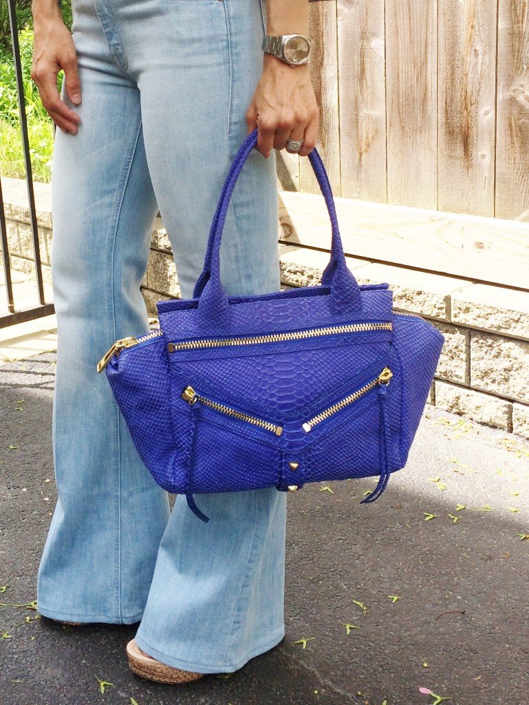 Denim on denim, wedges, and blue handbag