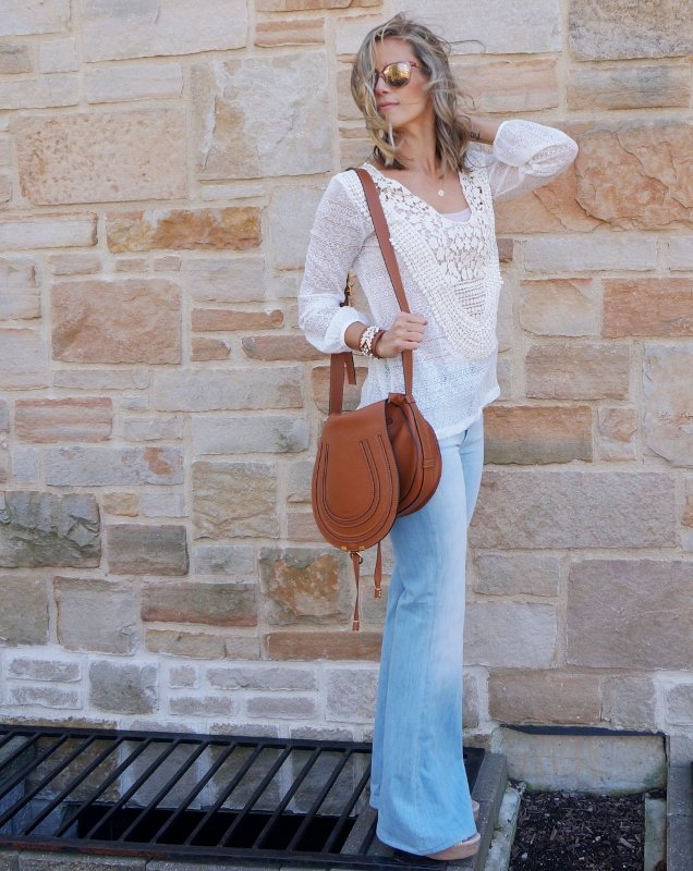 Lace top, flare jeans, Chloe bag, wedges, and sunglasses