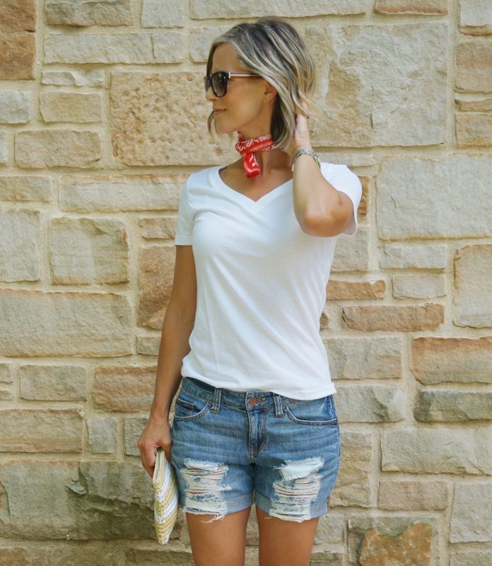 Summer style: white tee, denim shorts, red bandana, straw clutch, sunglasses, and Converse