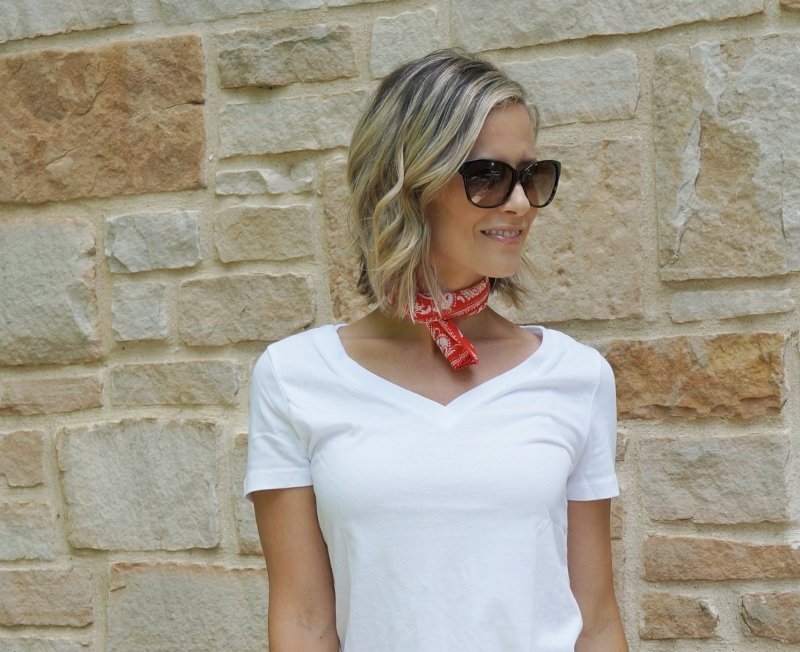 Summer style: white tee, denim shorts, red bandana, straw clutch, sunglasses, and Converse
