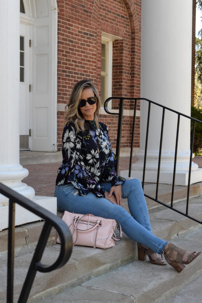 Floral top, denim, sunglasses, pink purse, and heels