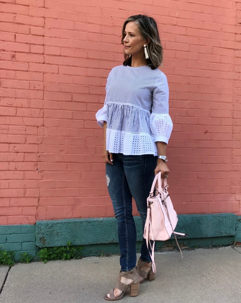Striped puff sleeve blouse, denim jeans, sandals, pink purse, and beaded earrings
