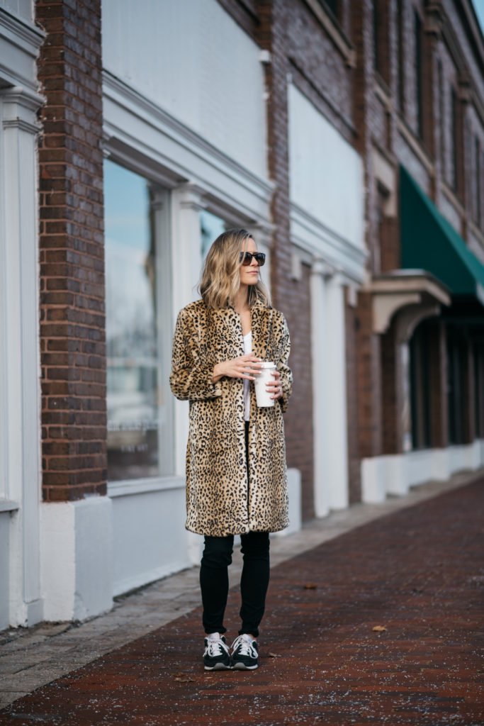 Leopard fur coat, skinny jeans, sneakers, and sunglasses