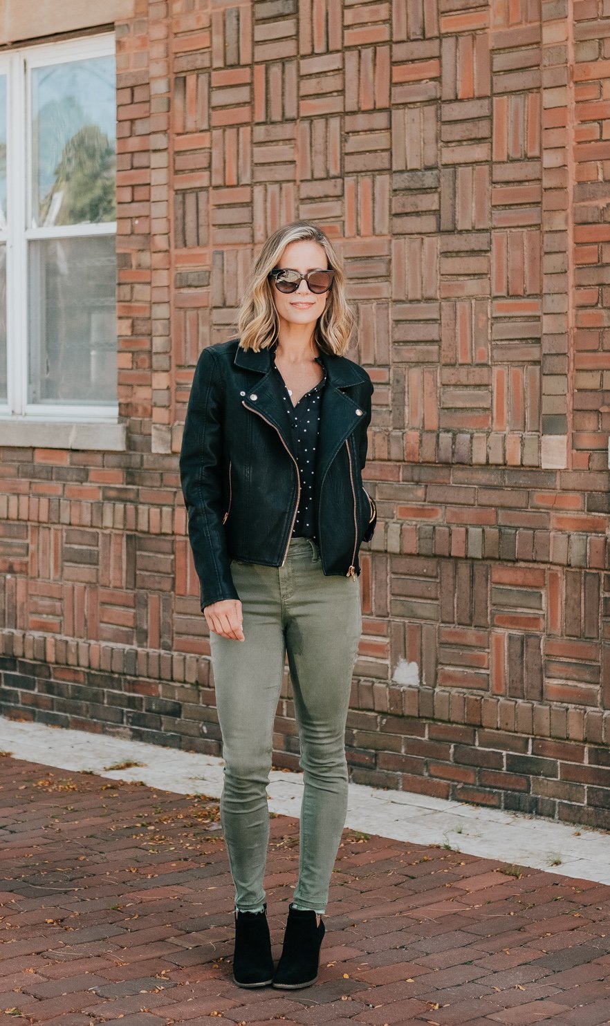 Budget friendly style: olive pants, polka dot blouse, moto jacket, booties, and sunglasses