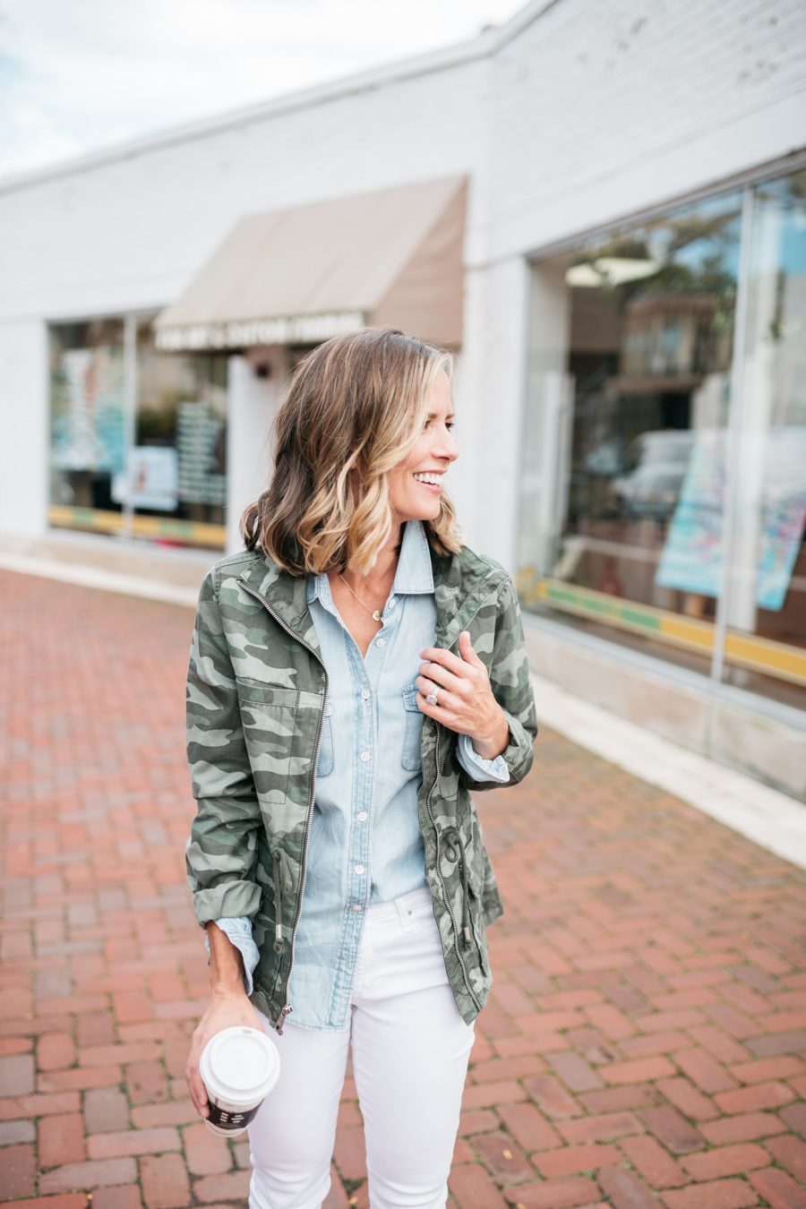 White denim for fall, chambray shirt, camo jacket, and sneakers