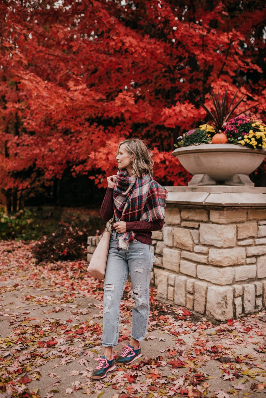 Thanksgiving Outfit Idea, cable knit sweater, plaid scarf, denim, sneakers, and tote bag