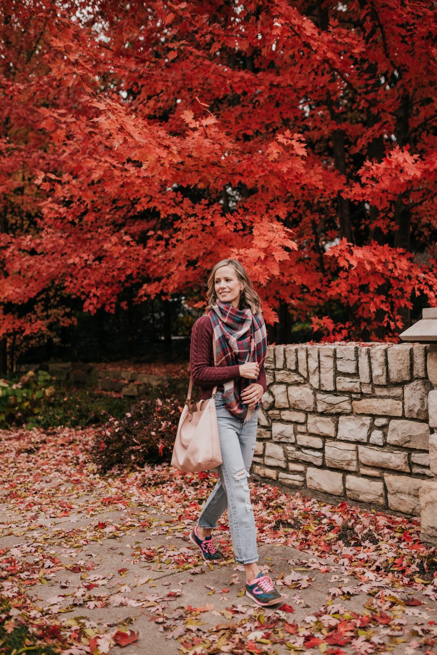 Thanksgiving Outfit Idea, cable knit sweater, plaid scarf, denim, sneakers, and tote bag