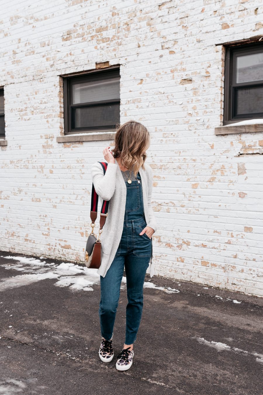Thanksgiving outfit ideas--overalls, cardigan, and sneakers