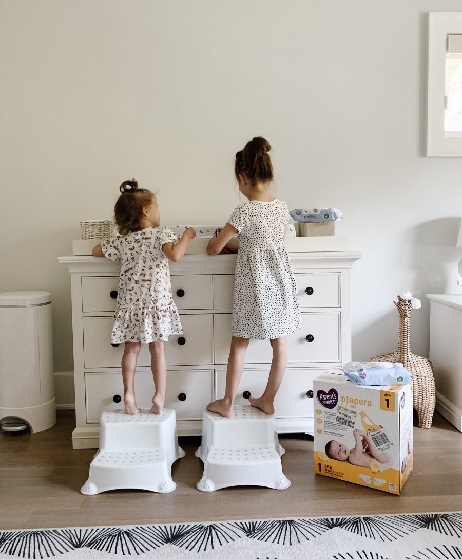 Sibling helpers changing diapers