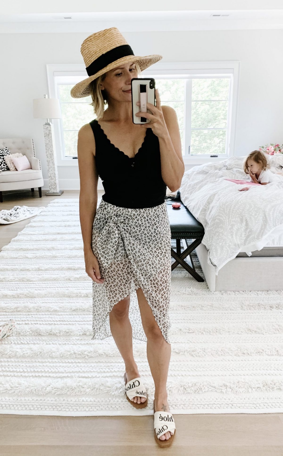 Suzanne wearing a scalloped Target one piece swimsuit postpartum, leopard sarong, Chloe sandals and straw hat