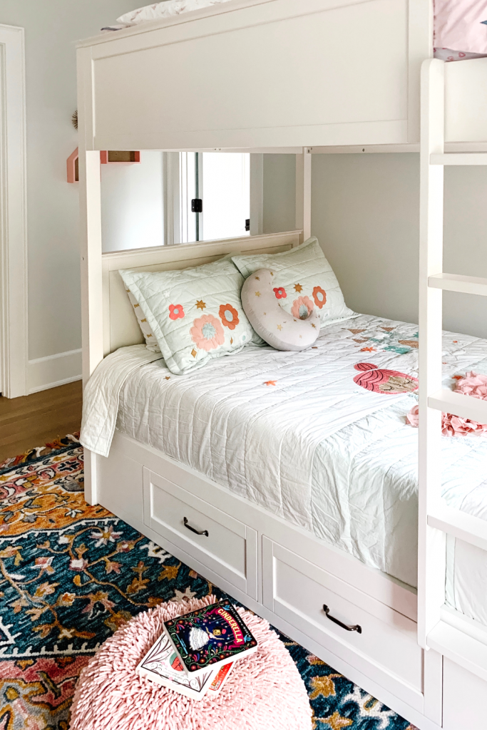 Transition to a big girl bedroom with bunkbeds, vibrant pops of color, and a cozy reading area.