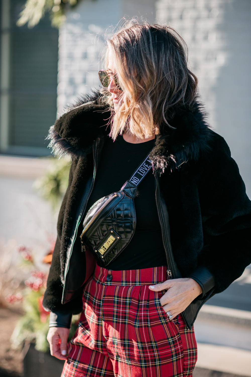 Suzanne wearing a faux fur bomber and plaid pants
