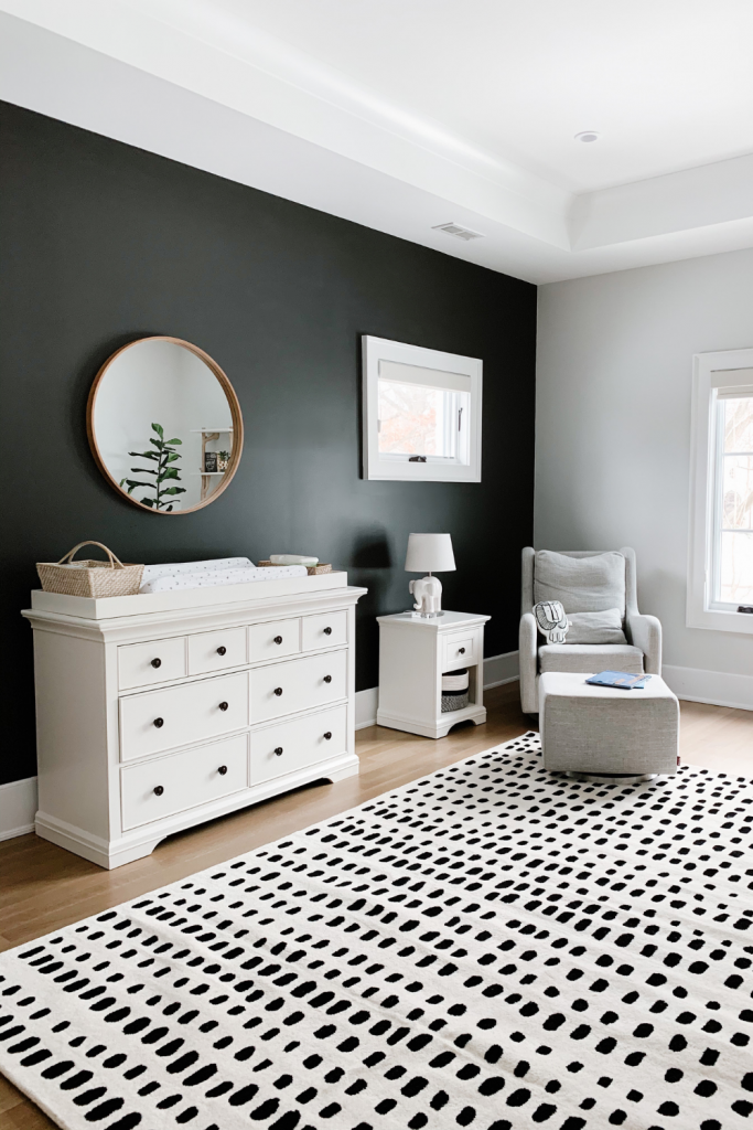 Revealing Baby Gray's nursery featuring a printed accent wall to pop against the minimalistic and sleek furniture and decor.