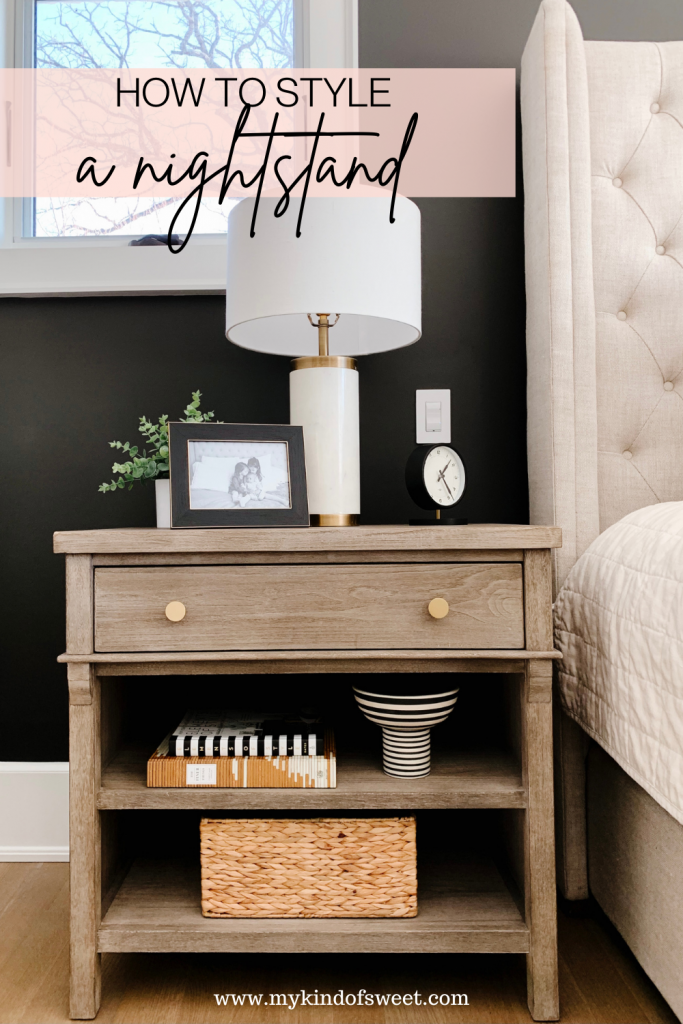 How to style a nightstand: lamp, table clock, framed pictured, basket, and books
