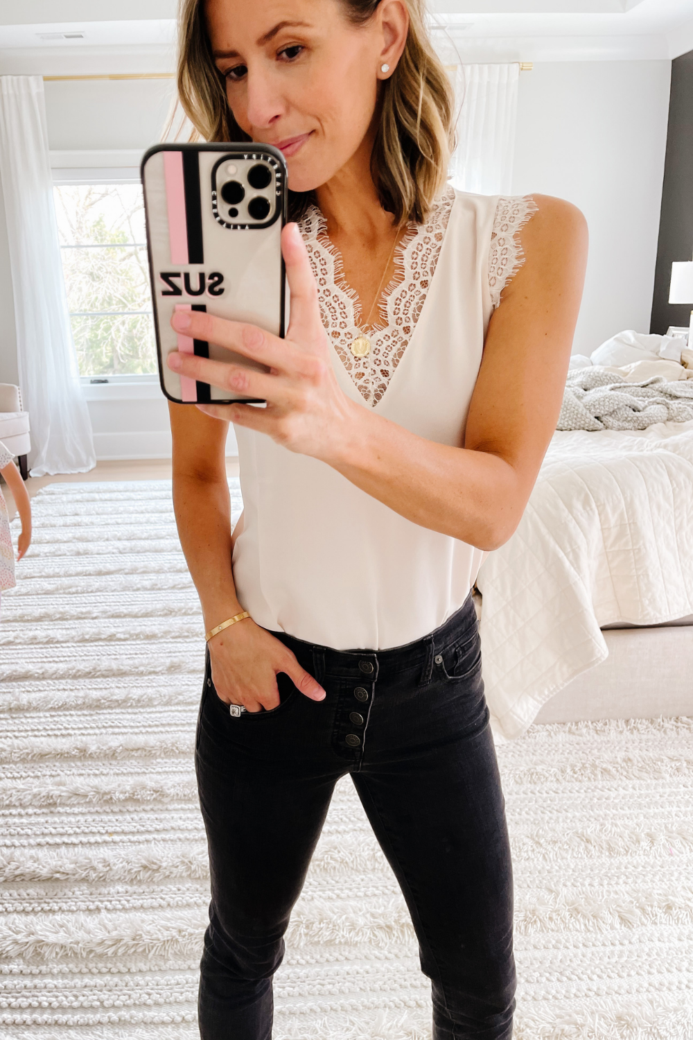 Suzanne wearing a lace trim cami and jeans