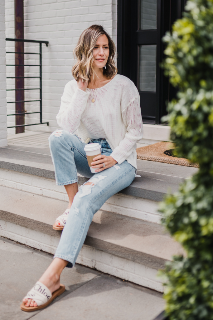 Spring outfit: white sweater, jeans, necklace, and sandals
