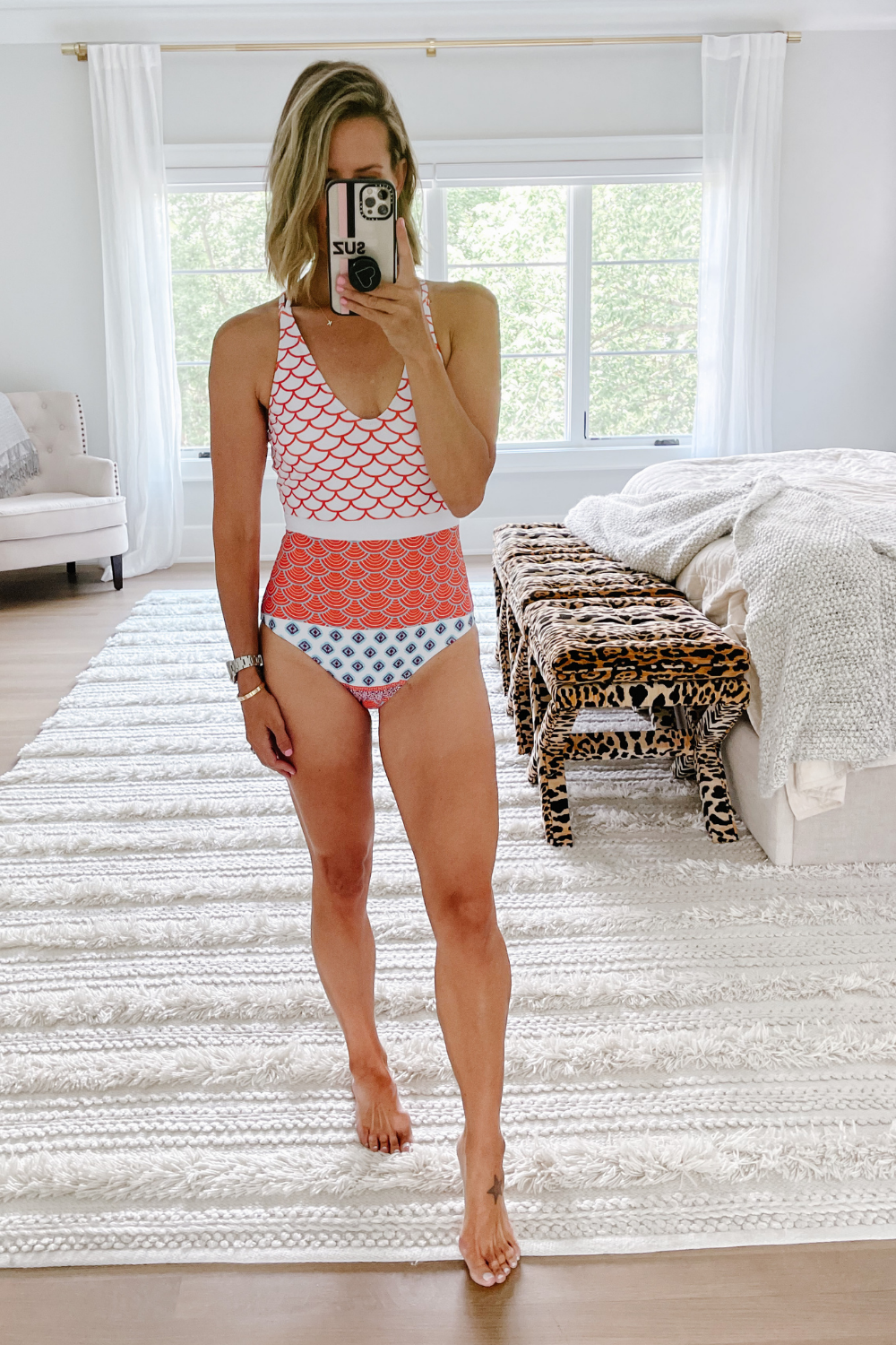 Suzanne wearing a printed Amazon one piece swimsuit