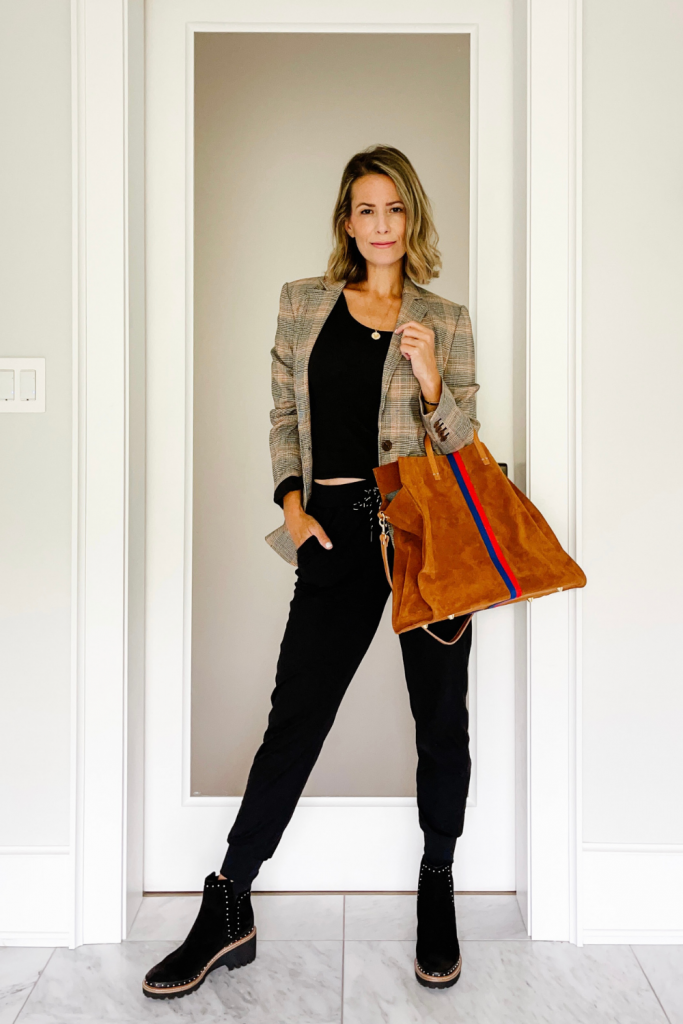 Suzanne wearing a plaid blazer, Zella joggers, booties, and a tote