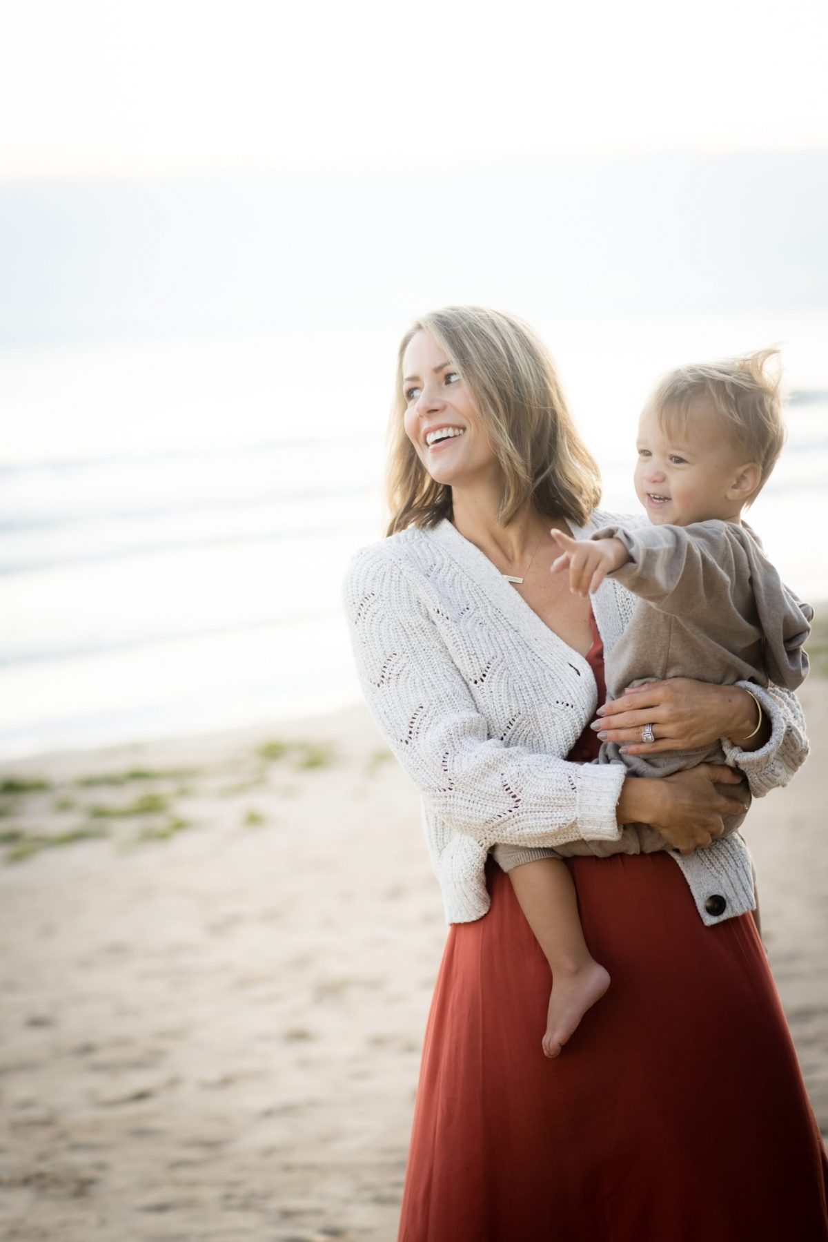 Suzanne and baby Gray on the beach for family photos