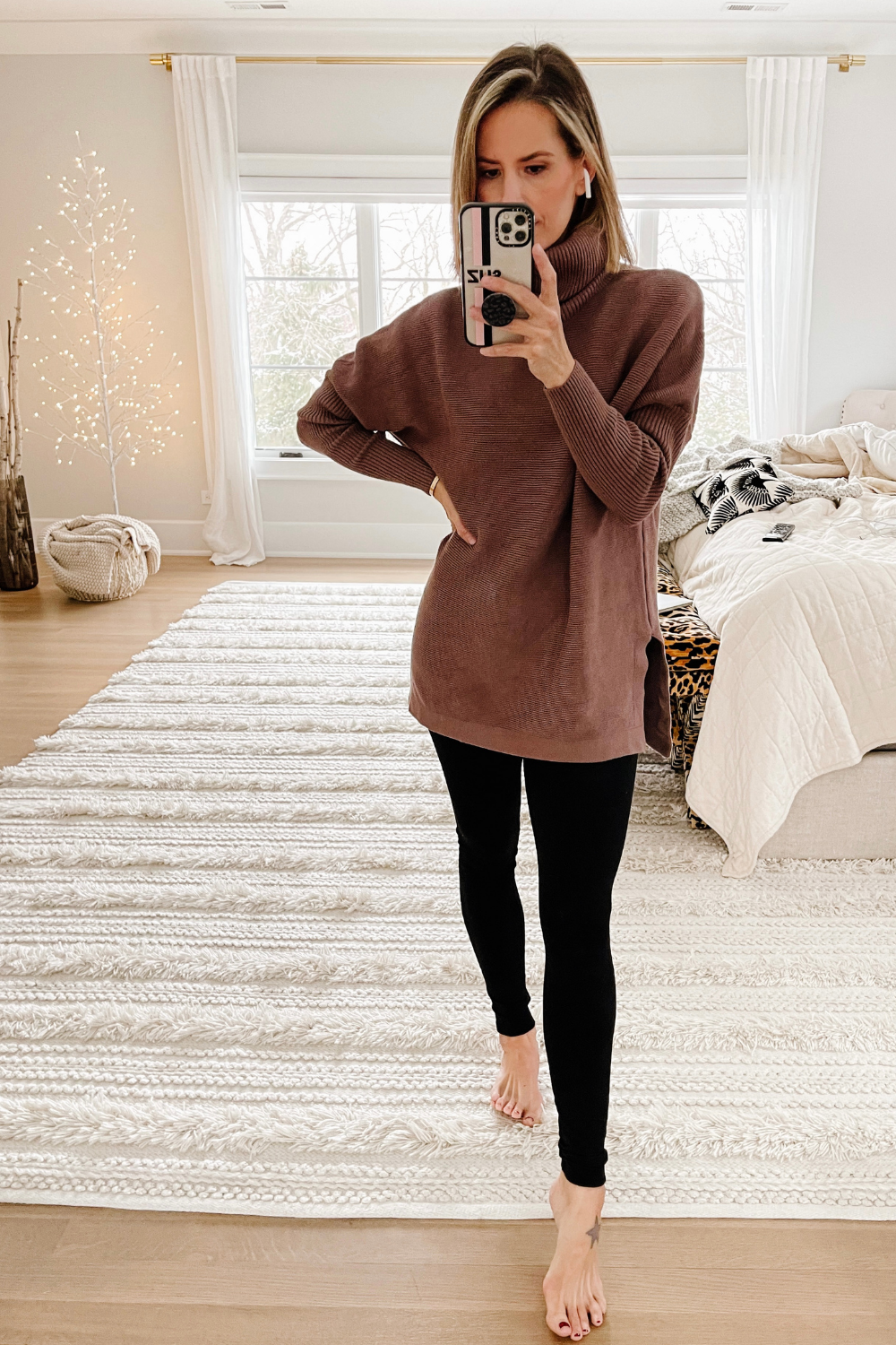 Suzanne wearing a turtleneck tunic and leggings