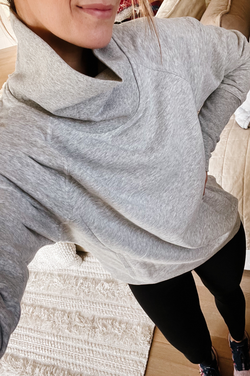 Suzanne wearing a grey pullover and leggings