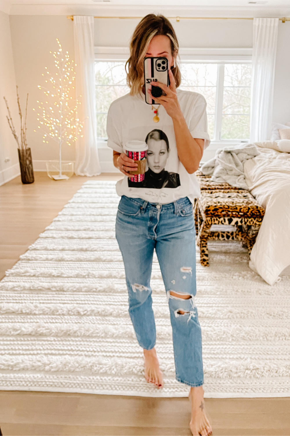 Suzanne wearing a graphic tee and denim