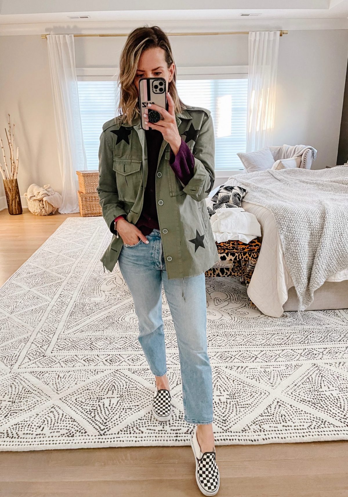 Suzanne wearing a star print jacket, denim, and Vans sneakers