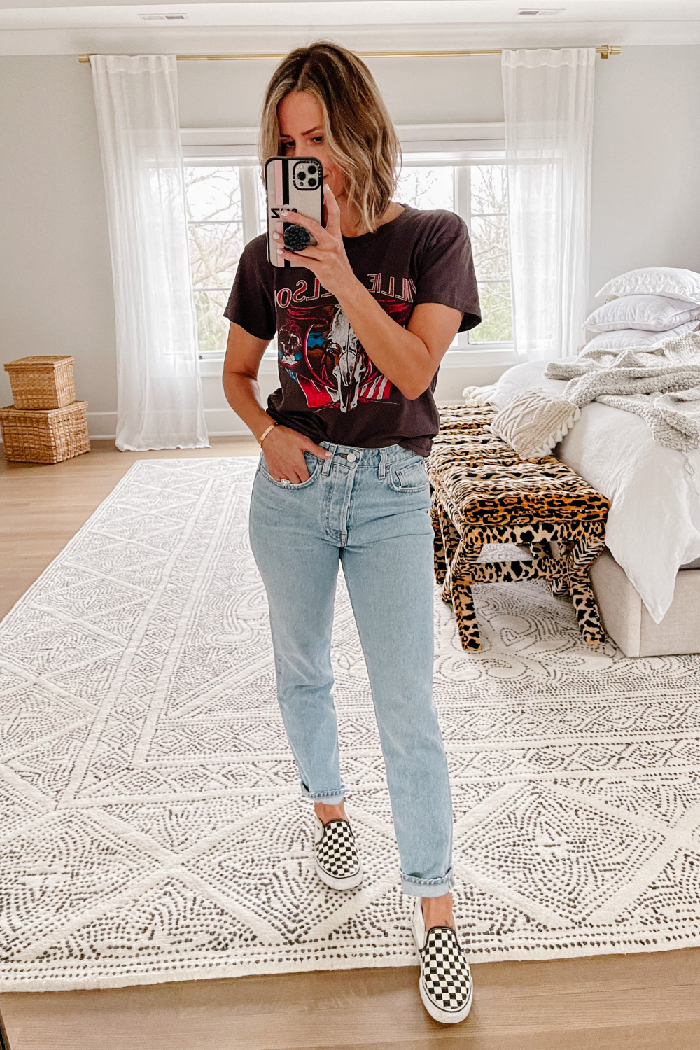Suzanne wearing a Willie Nelson tee, denim jeans, and Vans 