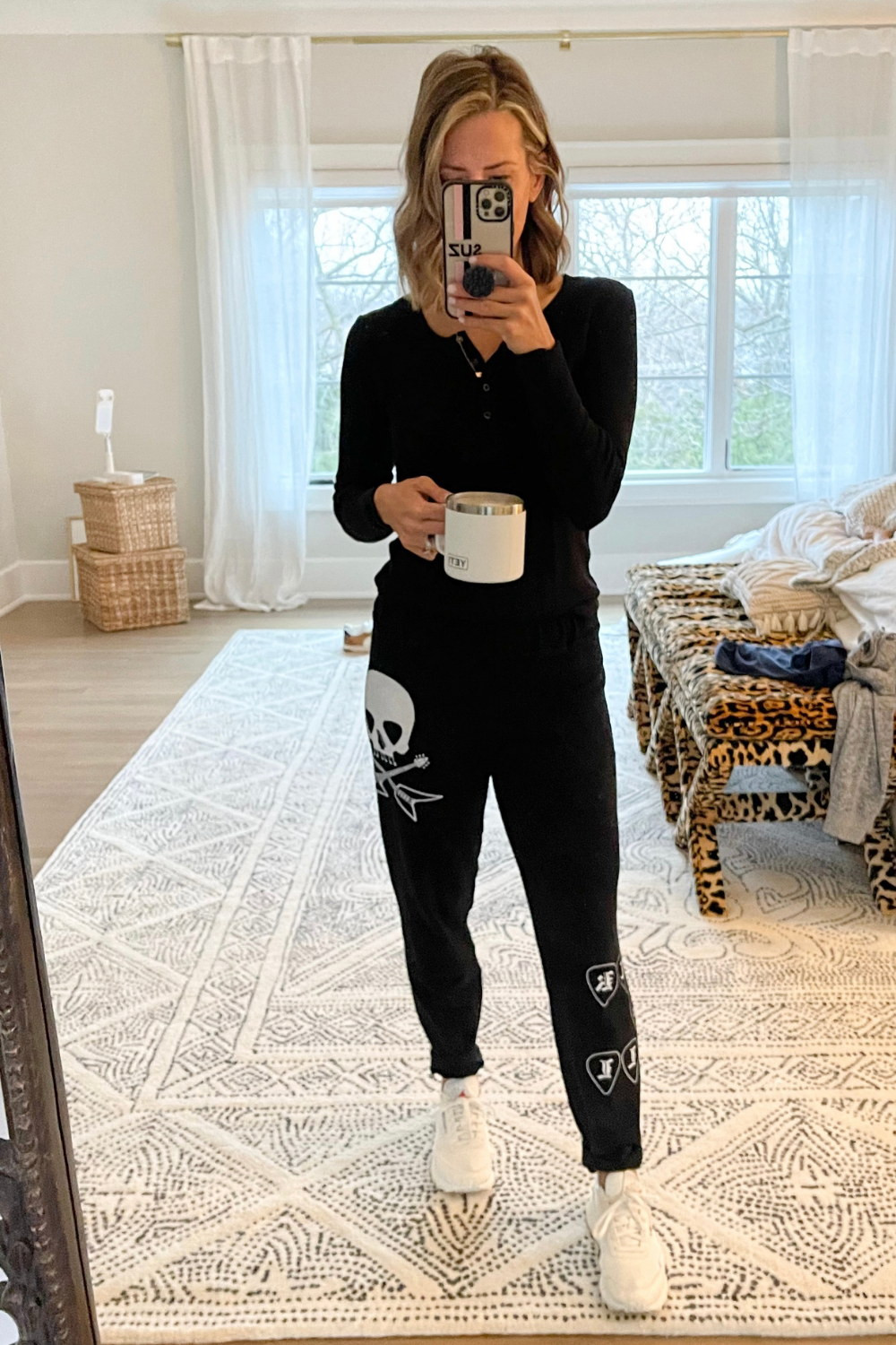 Suzanne wearing sweatpants, a henley, and sneakers