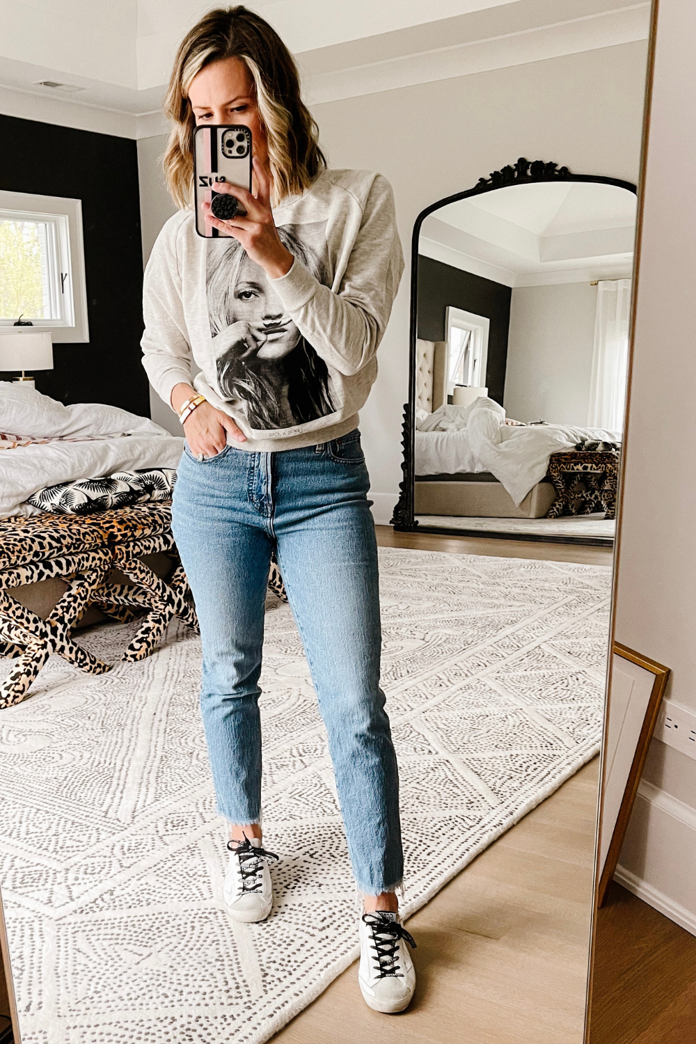 Suzanne wearing a Kate Moss pullover, vintage denim, and Golden Goose sneakers