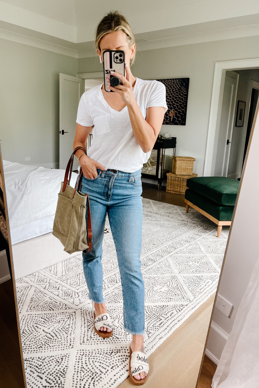 Suzanne wearing a white t-shirt and denim jeans