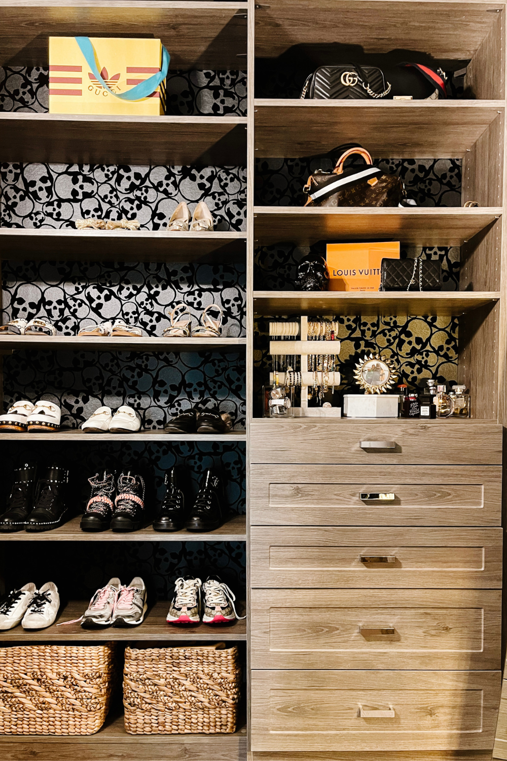 A view of Suzanne's closet storage, organization, and skull wallpaper