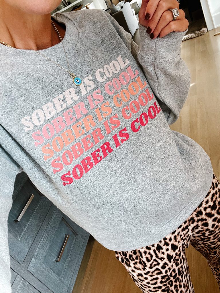 Suzanne wearing a "Sober is Cool" graphic sweatshirt