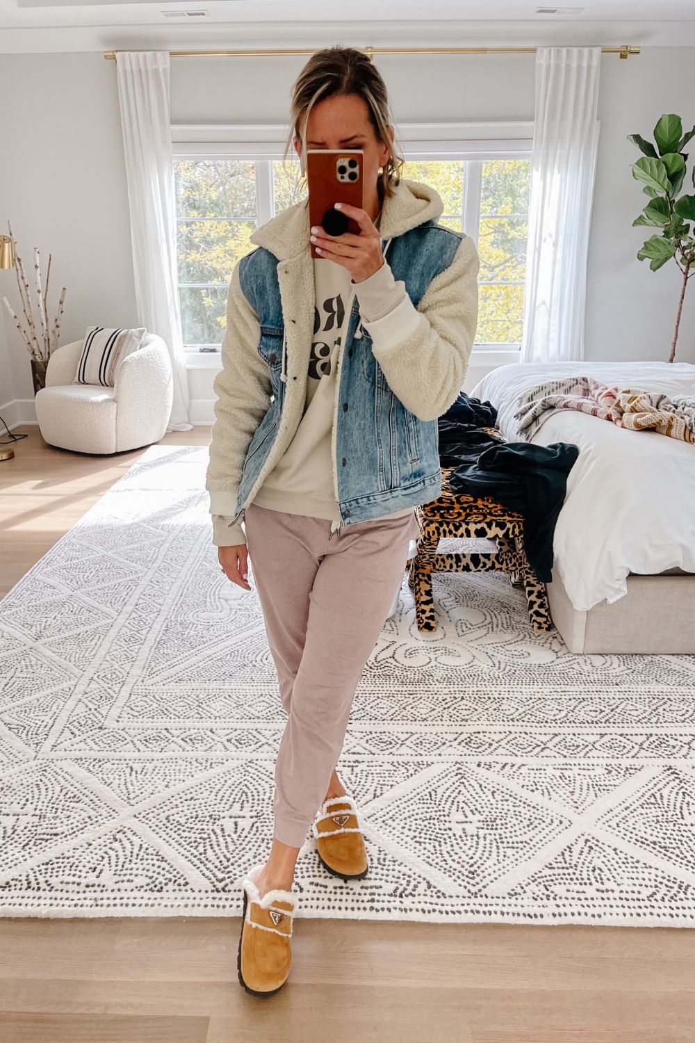 Suzanne wearing a Pro Roe crewneck, joggers, and a denim sherpa jacket