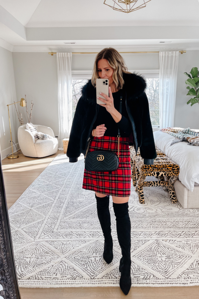 Suzanne wearing a plaid pencil skirt and faux fur jacket for the holidays