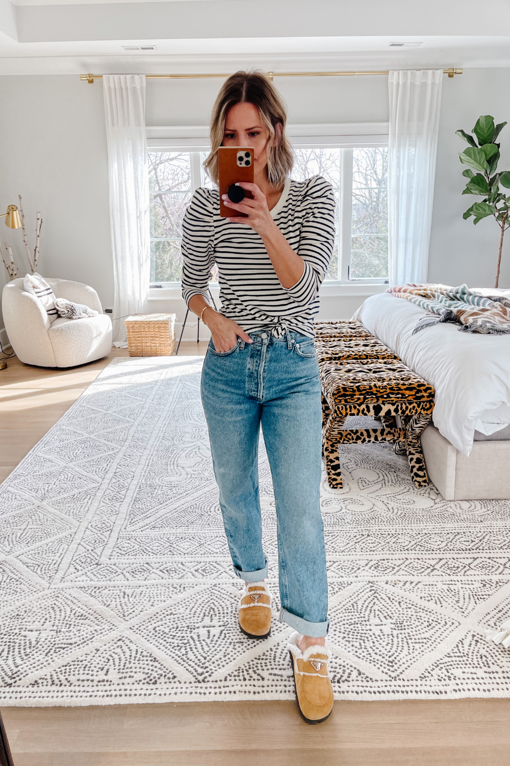 Suzanne wearing a striped puff sleeve top and denim jeans