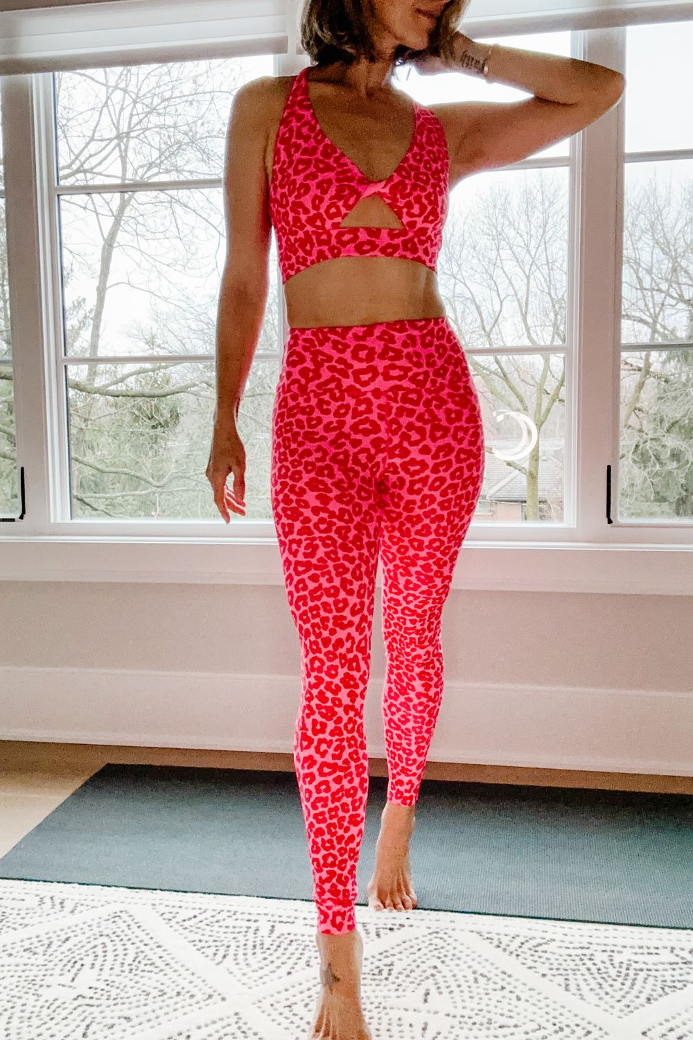 Suzanne wearing a pink leopard activewear set 