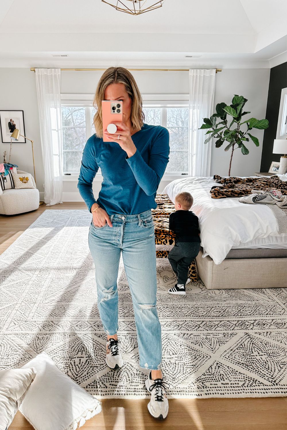 Suzanne wearing a long sleeve tee, jeans, and sneakers