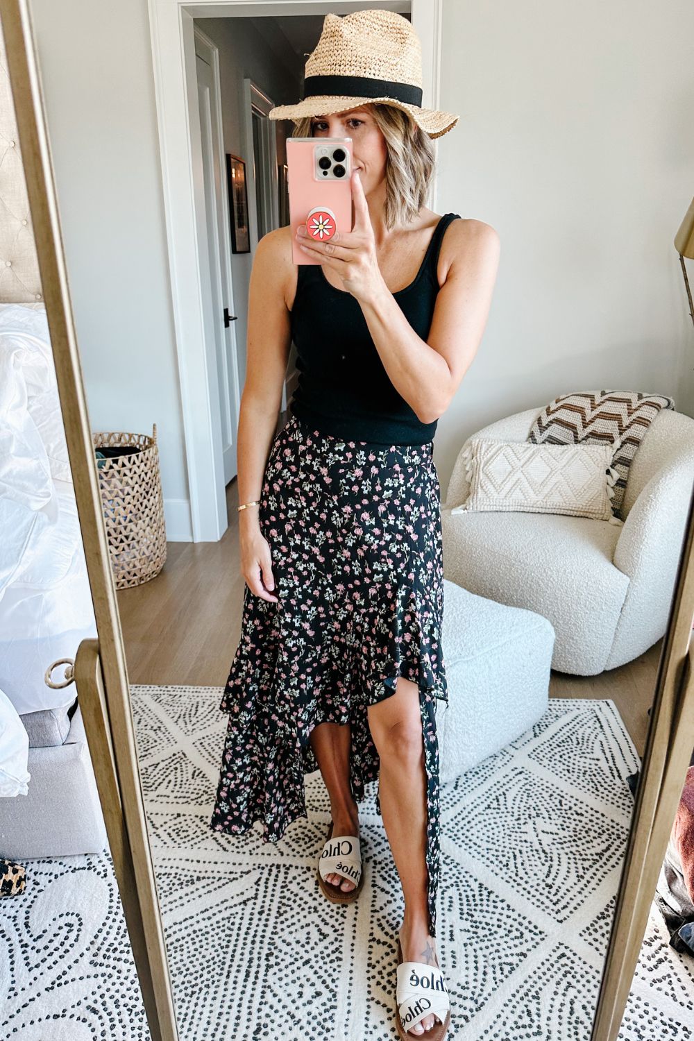 Suzanne wearing a tank and floral ruffle maxi skirt