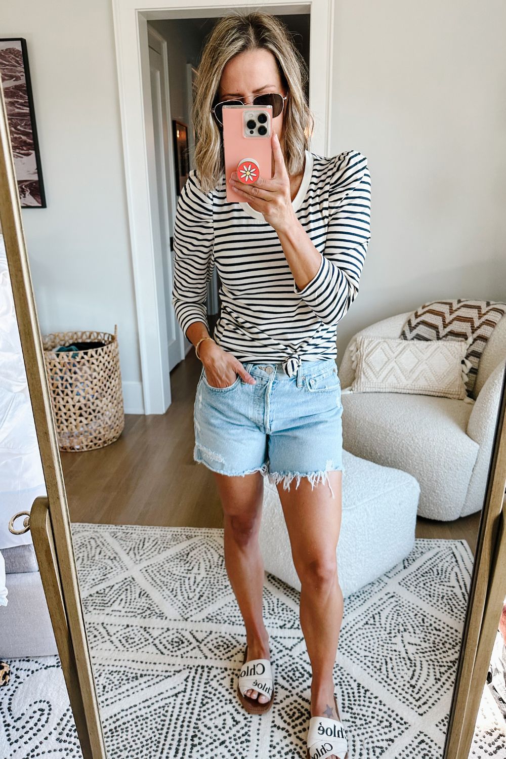 Suzanne wearing a striped puff sleeve top and denim shorts