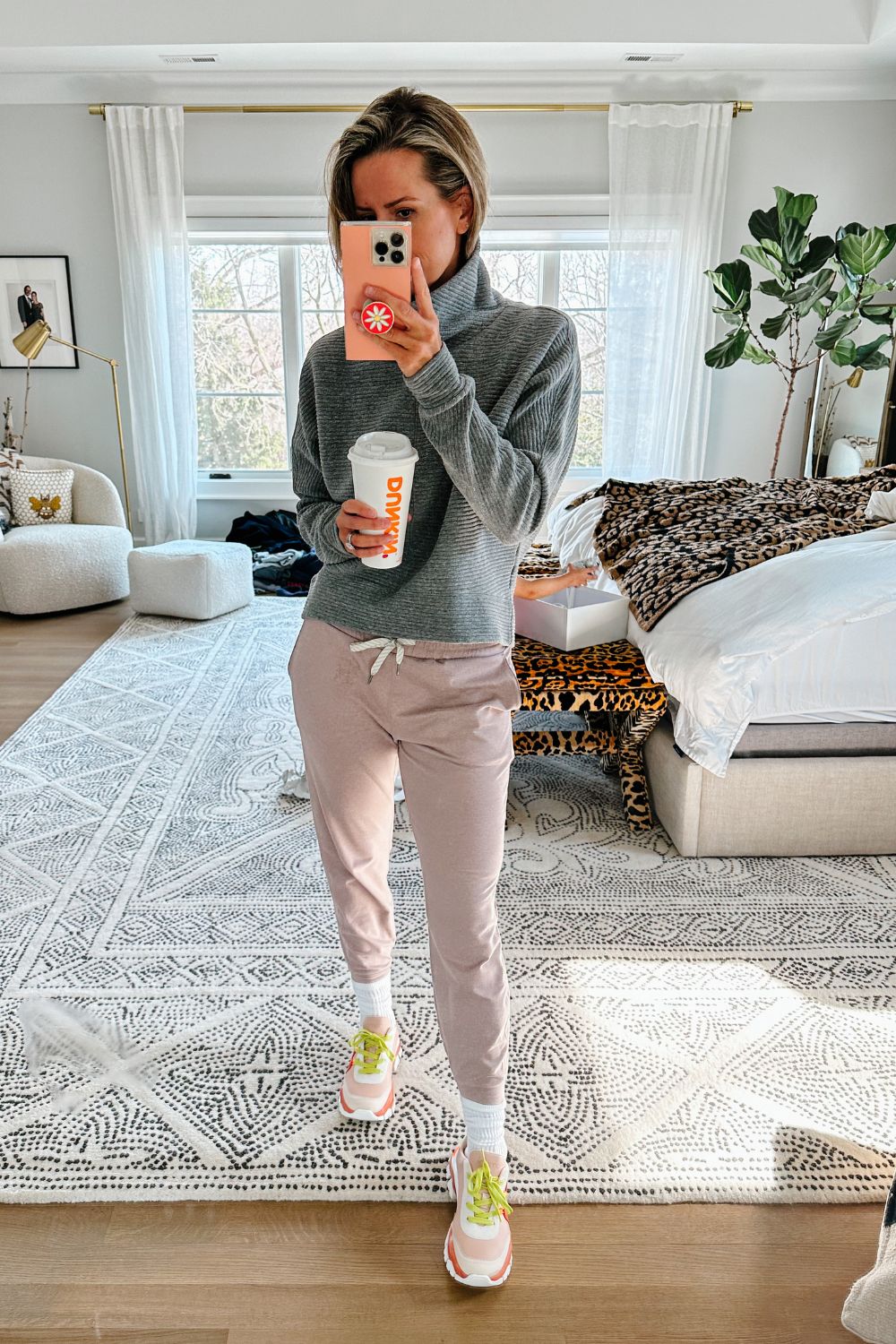Suzanne wearing a grey pullover and joggers