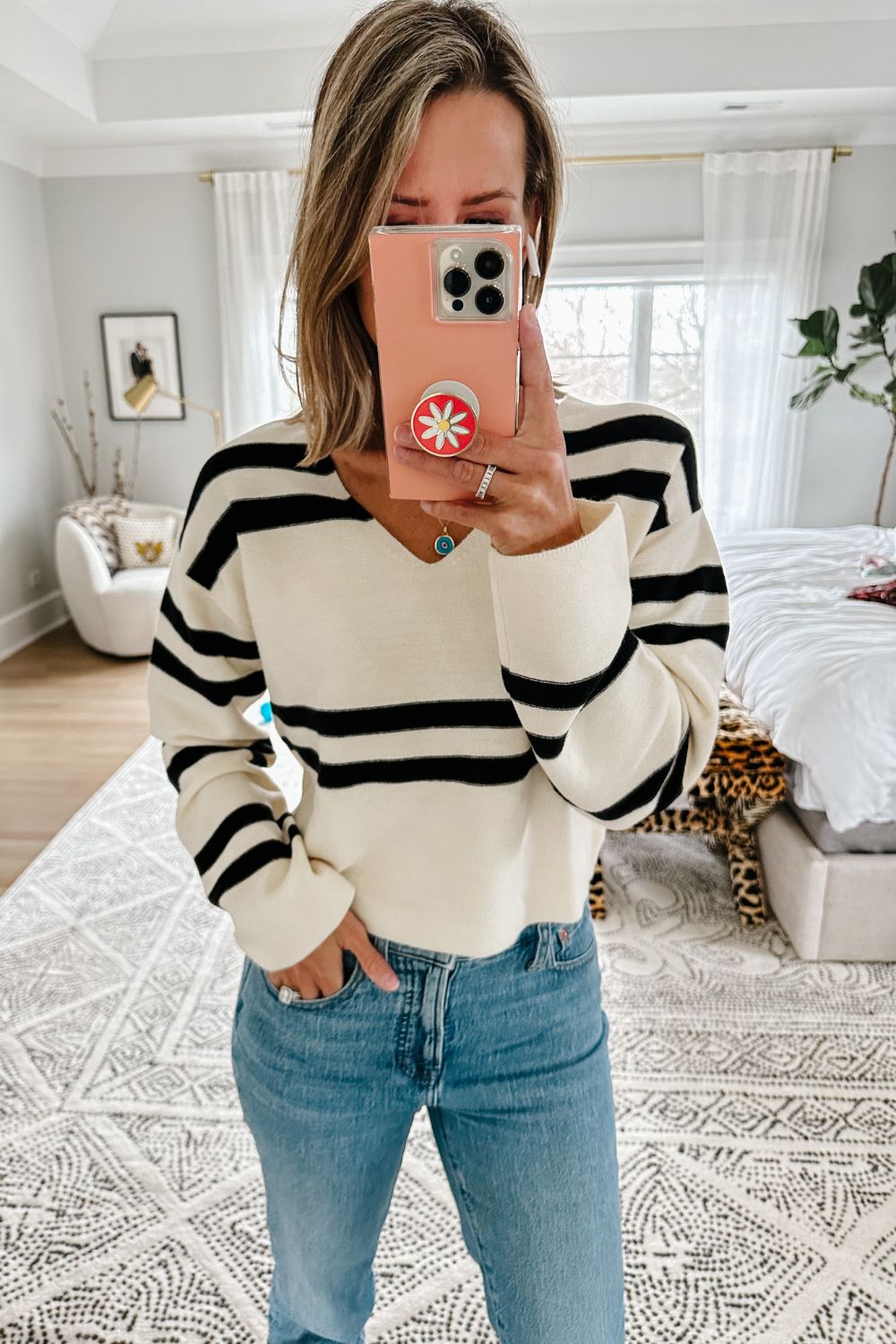 Suzanne wearing a striped sweater from Evereve