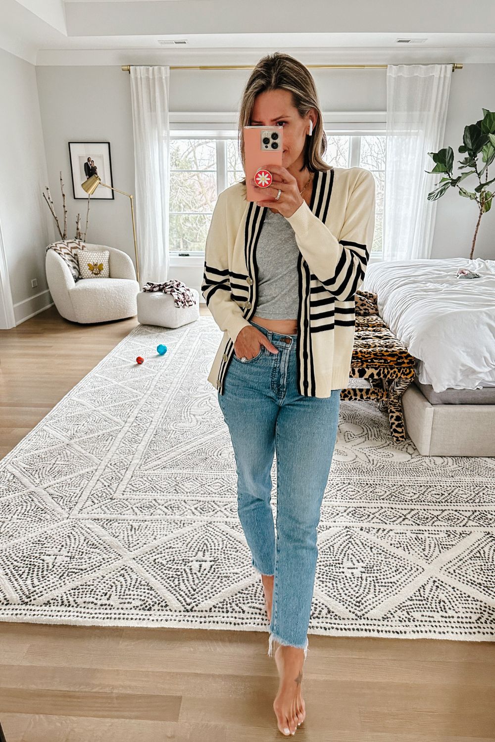 Suzanne wearing a striped cardigan from Evereve with a grey tank and jeans