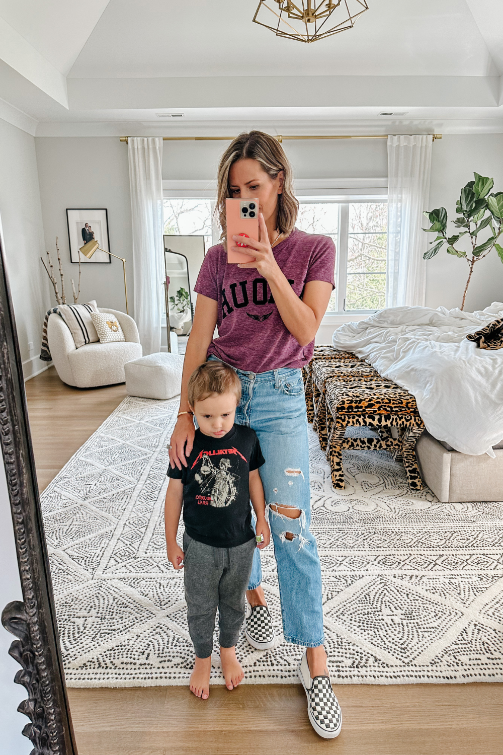 Suzanne and her son, she's wearing a graphic t-shirt and denim jeans
